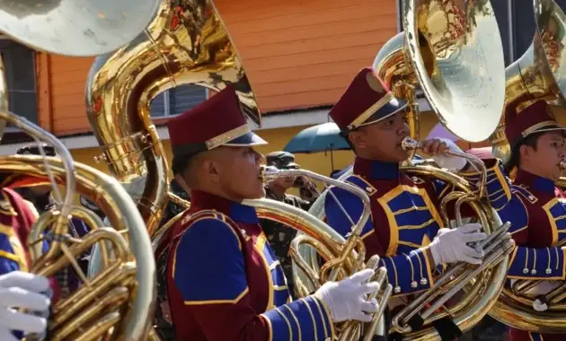 marching band players playing tuba instruments