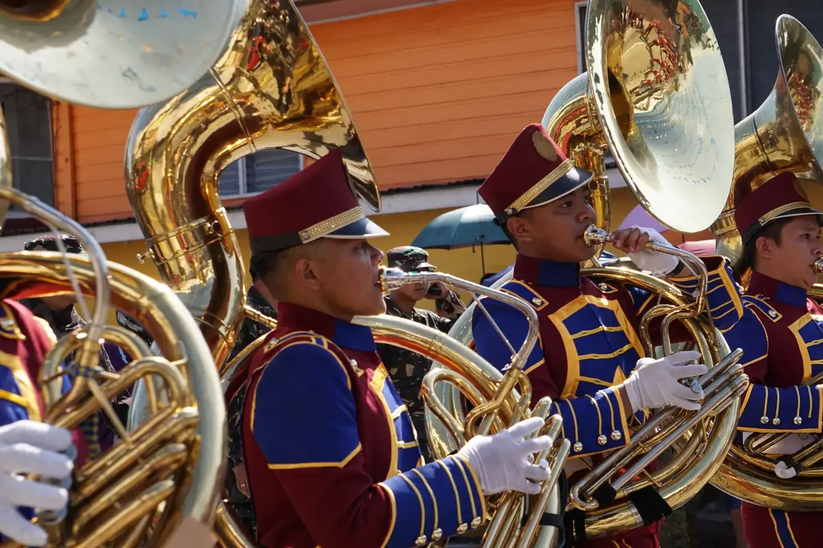 marching band players playing tuba instruments